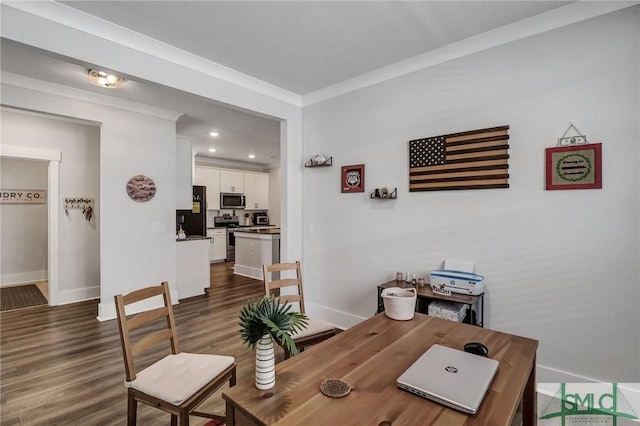 office space with baseboards, dark wood-type flooring, and crown molding