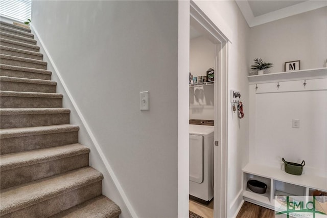 stairs with washer / dryer, wood finished floors, and baseboards