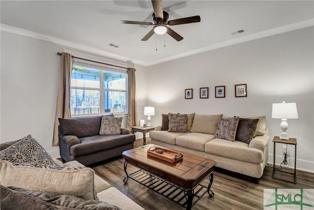 living area featuring visible vents, wood finished floors, and ornamental molding