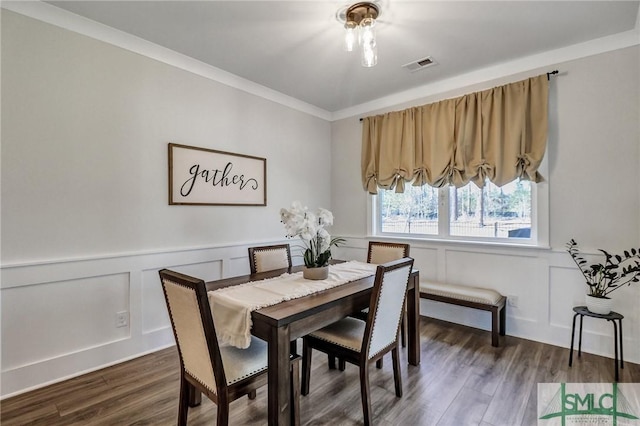 dining room featuring visible vents, a wainscoted wall, and wood finished floors