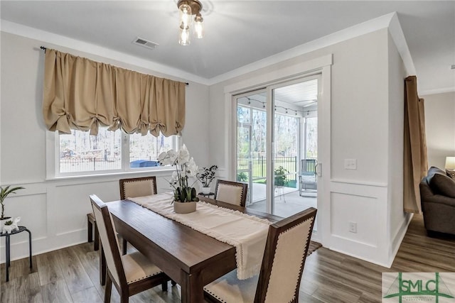 dining area featuring visible vents, plenty of natural light, and wood finished floors