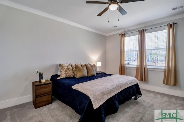 bedroom featuring baseboards, light colored carpet, visible vents, and ornamental molding