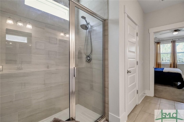 ensuite bathroom featuring tile patterned floors, a stall shower, and ensuite bathroom