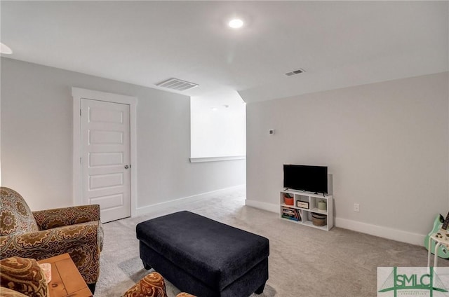 living room featuring visible vents, light carpet, and baseboards