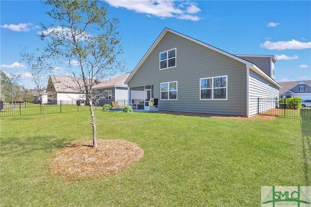 back of property featuring a lawn, a fenced backyard, and a sunroom