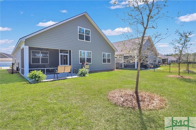 back of property with a yard, a fenced backyard, and a sunroom