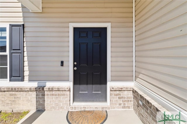 property entrance with brick siding