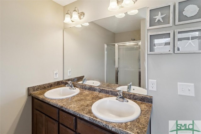 full bathroom with a sink, double vanity, and a shower stall