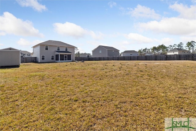 view of yard with an outbuilding and a fenced backyard