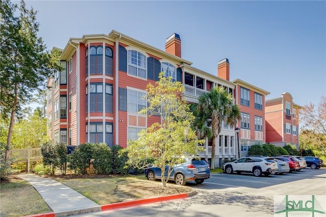 view of property featuring uncovered parking