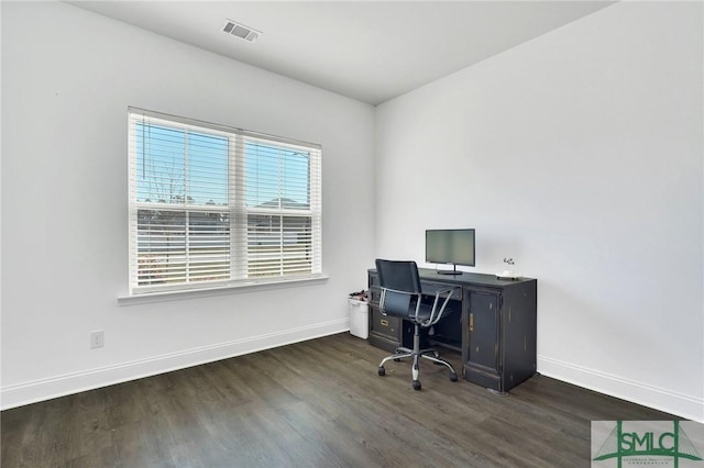 office space featuring visible vents, dark wood-type flooring, and baseboards