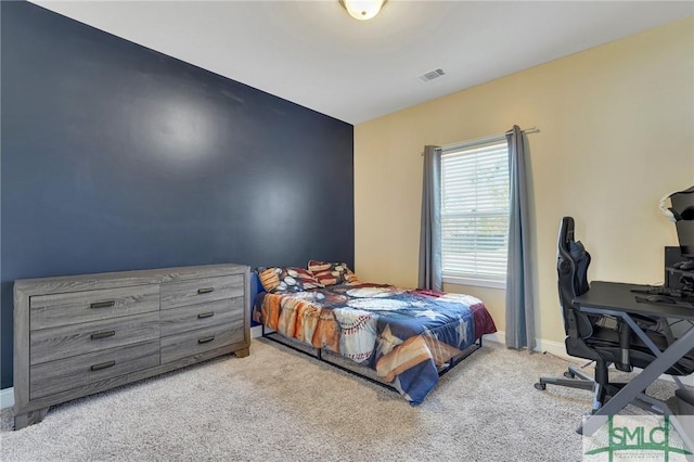 carpeted bedroom with visible vents and baseboards