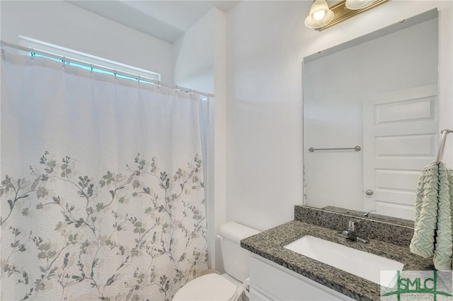 bathroom with a shower with shower curtain, toilet, and vanity