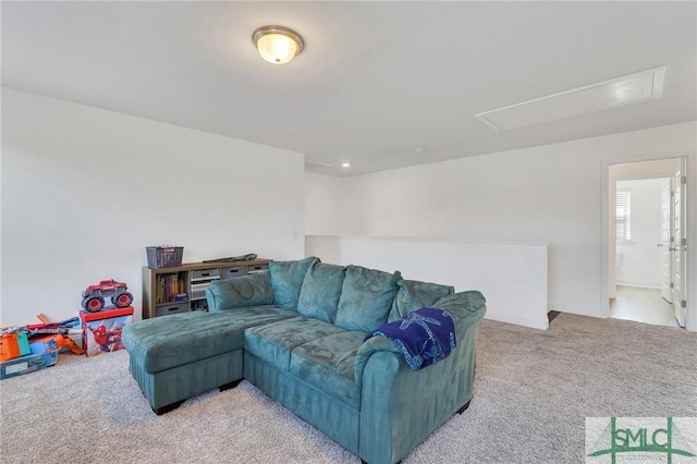 living room with light colored carpet and attic access