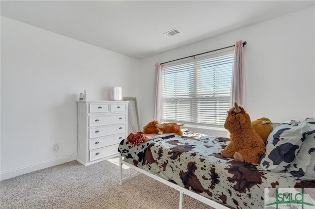 carpeted bedroom featuring visible vents and baseboards