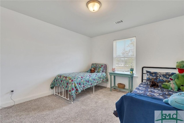 carpeted bedroom with visible vents and baseboards