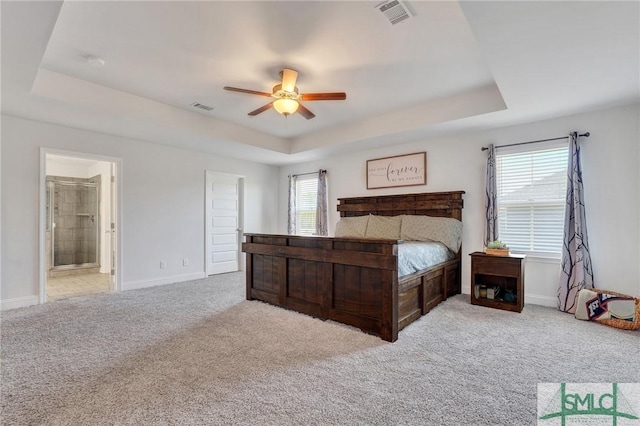 bedroom featuring a raised ceiling, carpet flooring, and visible vents