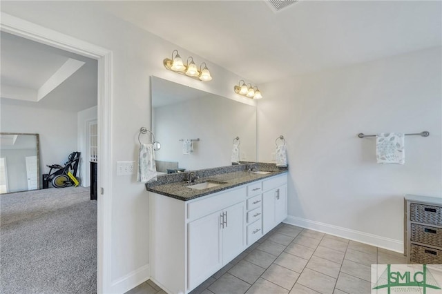 full bathroom with double vanity, baseboards, visible vents, and a sink