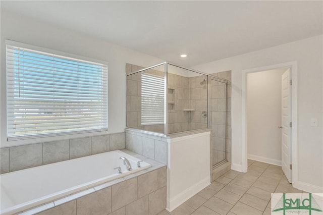 full bathroom with tile patterned floors, a stall shower, baseboards, and a garden tub