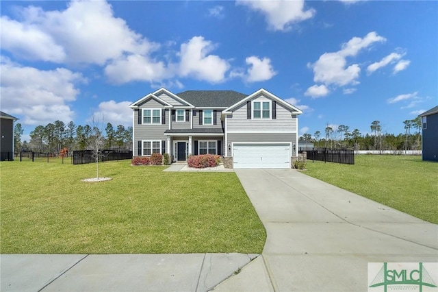 view of front facade with an attached garage, concrete driveway, a front yard, and fence