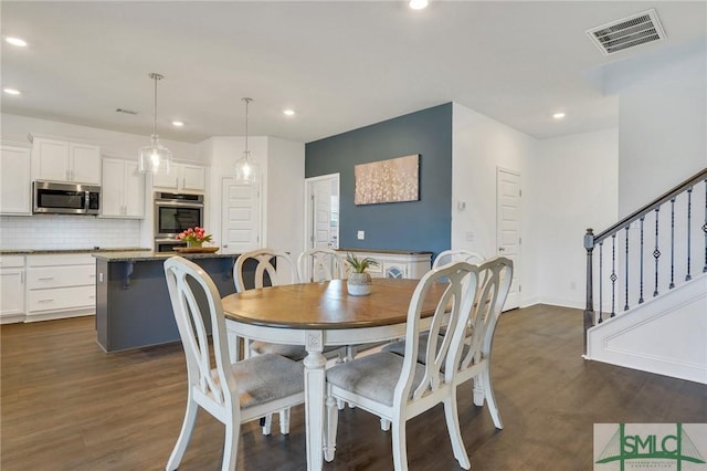 dining room featuring recessed lighting, visible vents, dark wood finished floors, and stairs