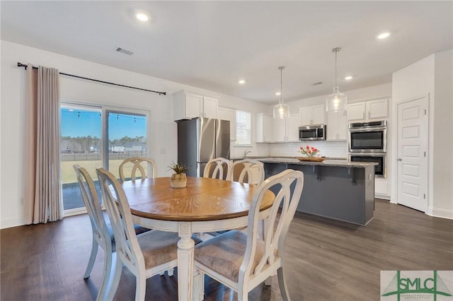 dining room featuring recessed lighting, dark wood-style floors, and visible vents