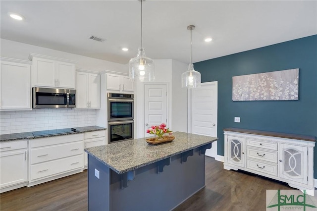 kitchen featuring white cabinetry, dark wood-style floors, stone counters, and appliances with stainless steel finishes