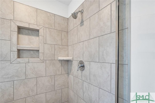 interior details with a tile shower