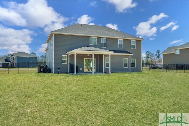 back of property with a yard, a shingled roof, a fenced backyard, and a patio area