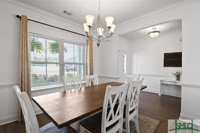 dining room featuring ornamental molding, a notable chandelier, wood finished floors, and visible vents
