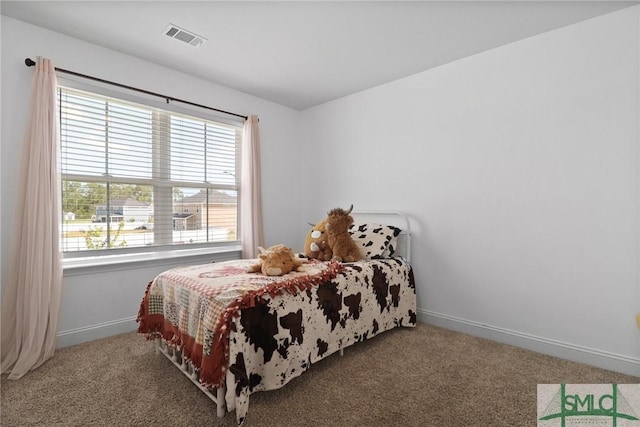 carpeted bedroom with baseboards, multiple windows, and visible vents