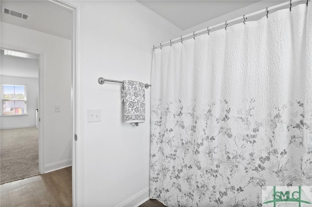 bathroom featuring baseboards and visible vents