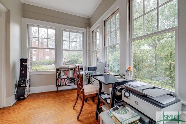 office area with crown molding, baseboards, and light wood finished floors