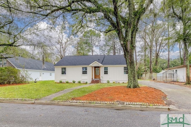 view of front of home with a front yard, driveway, and crawl space