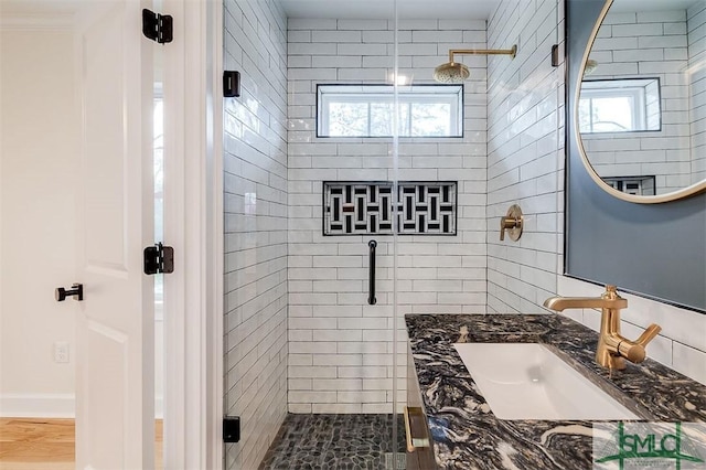 bathroom featuring vanity, a stall shower, and a wealth of natural light