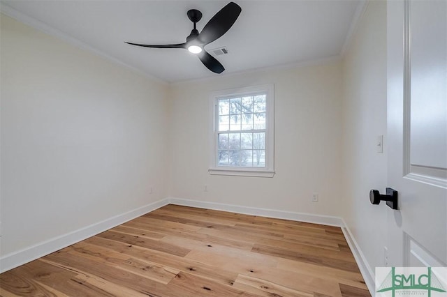 empty room featuring visible vents, light wood-style flooring, ornamental molding, baseboards, and ceiling fan