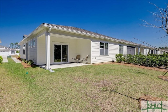 back of property with a yard and a patio