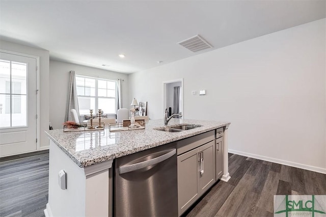 kitchen featuring visible vents, a sink, stainless steel dishwasher, dark wood finished floors, and light stone countertops