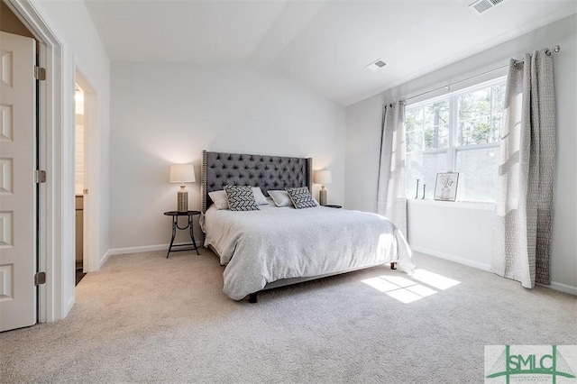 bedroom featuring carpet flooring, visible vents, baseboards, and lofted ceiling