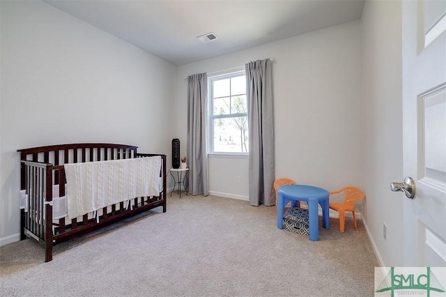 bedroom featuring visible vents, carpet floors, a nursery area, and baseboards