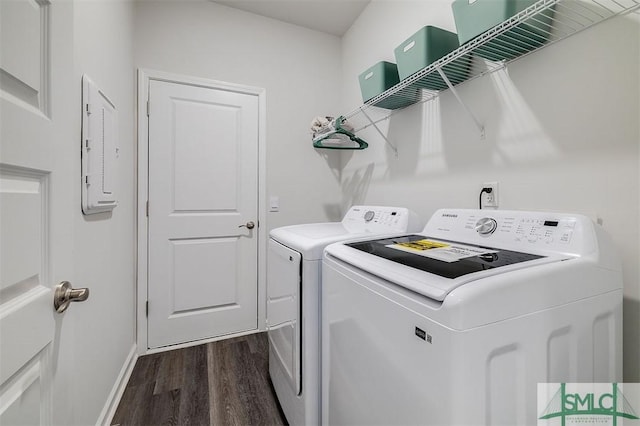 laundry area featuring dark wood finished floors, laundry area, baseboards, and independent washer and dryer