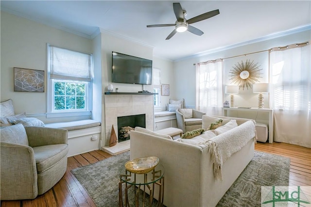 living room with hardwood / wood-style flooring, plenty of natural light, and crown molding