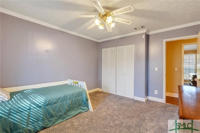 carpeted bedroom featuring ceiling fan, baseboards, visible vents, and ornamental molding