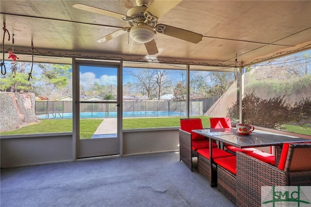 unfurnished sunroom featuring a healthy amount of sunlight and ceiling fan