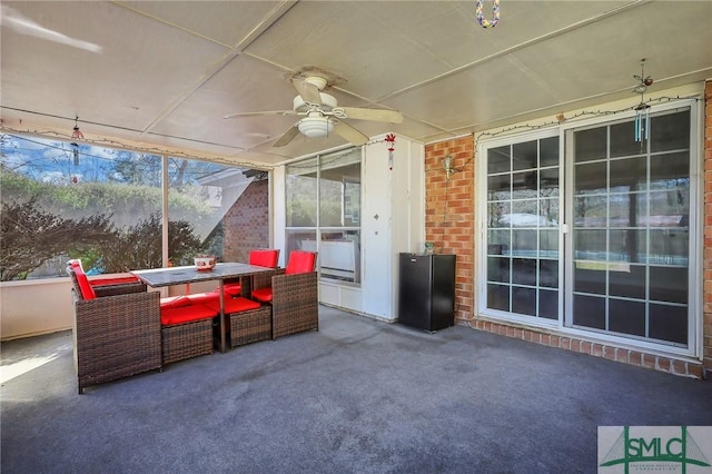 view of patio with outdoor dining space and a ceiling fan