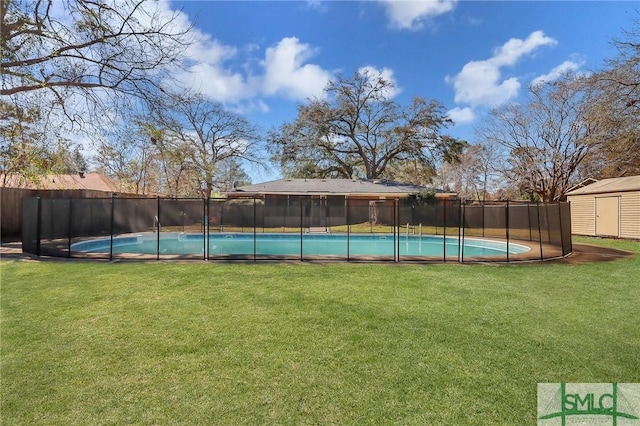 view of pool with a yard, a fenced backyard, a fenced in pool, and a shed