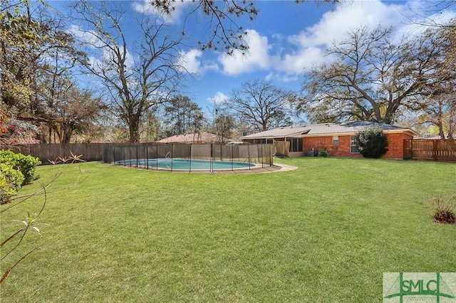 view of yard featuring a fenced in pool and a fenced backyard