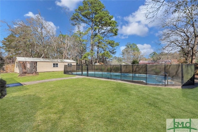 view of yard with an outbuilding, a fenced in pool, and fence