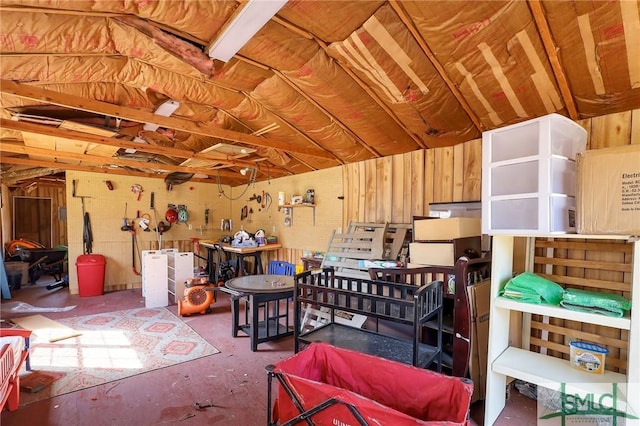 misc room featuring a workshop area and unfinished concrete flooring