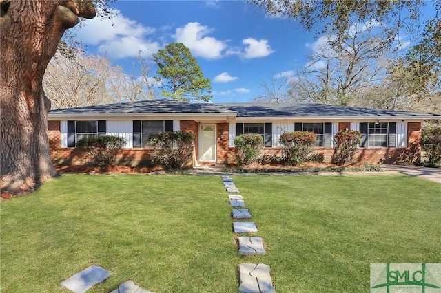 single story home with a front yard and brick siding